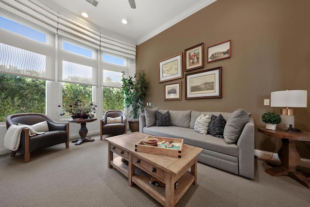 carpeted living room featuring ceiling fan and ornamental molding