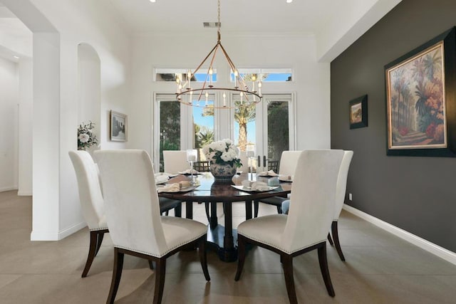 dining area with crown molding and a notable chandelier