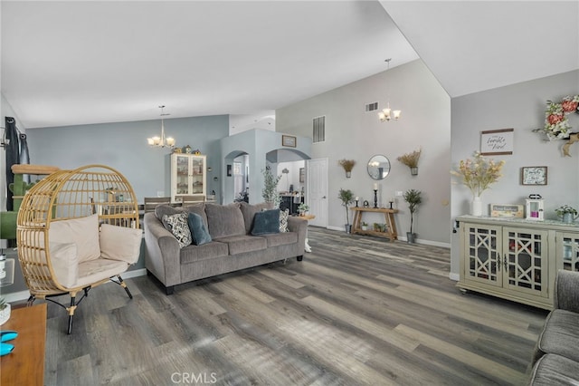 living room featuring high vaulted ceiling, dark wood-type flooring, and a chandelier