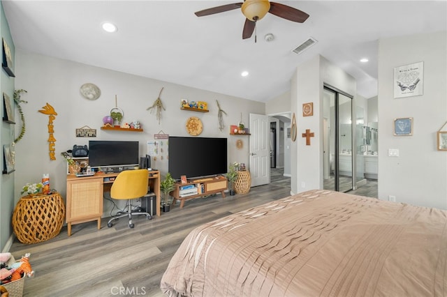 bedroom with hardwood / wood-style floors, lofted ceiling, connected bathroom, a closet, and ceiling fan