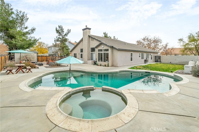 view of swimming pool with an in ground hot tub and a patio area