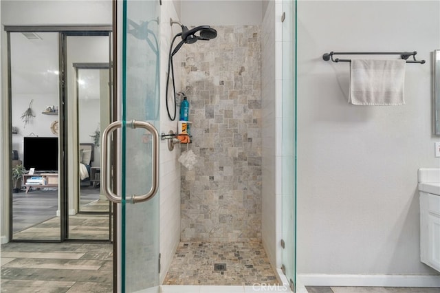 bathroom with walk in shower and vanity