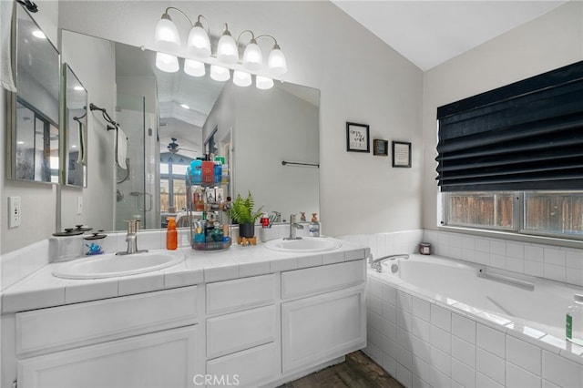 bathroom featuring plus walk in shower, lofted ceiling, hardwood / wood-style flooring, and vanity