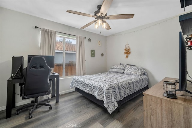 bedroom with ceiling fan and dark hardwood / wood-style floors