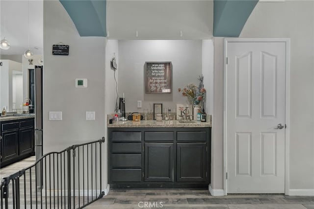 bar with stainless steel fridge and sink