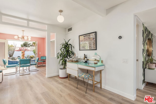 interior space featuring beam ceiling, light wood-type flooring, and an inviting chandelier