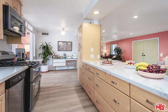 kitchen featuring light brown cabinets, appliances with stainless steel finishes, and light hardwood / wood-style flooring