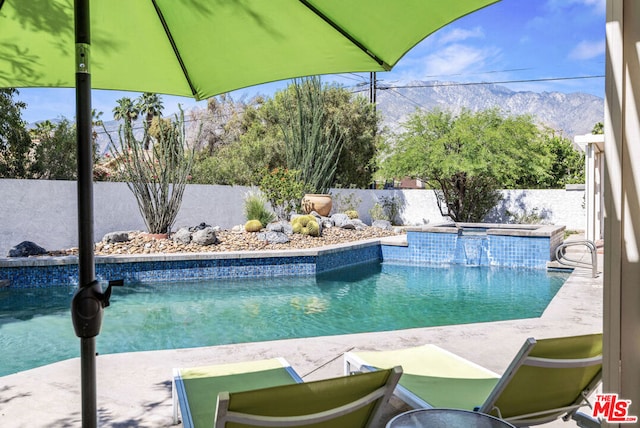 view of swimming pool featuring a mountain view