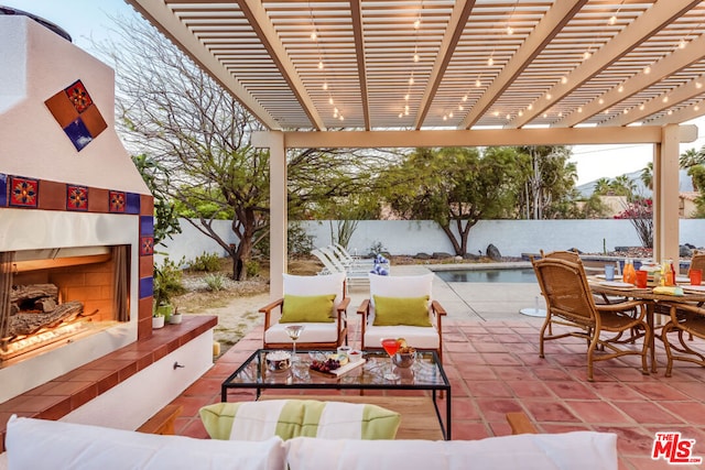 view of patio / terrace featuring a water view, a pergola, and an outdoor living space with a fireplace