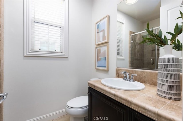 bathroom featuring toilet, vanity, and an enclosed shower