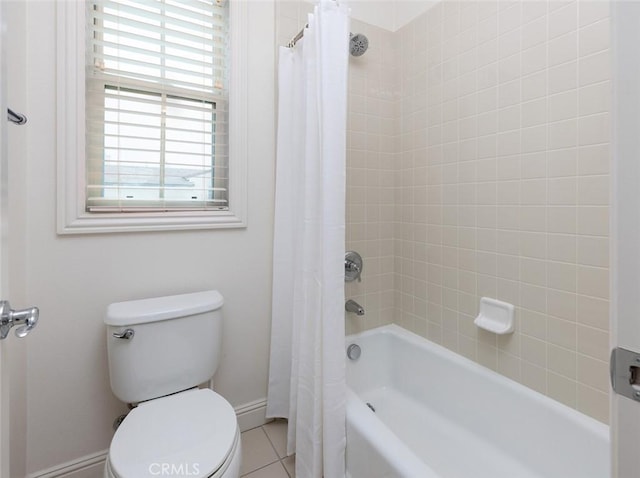 bathroom featuring toilet, tile patterned flooring, a wealth of natural light, and shower / bath combination with curtain