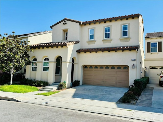 mediterranean / spanish home with a garage