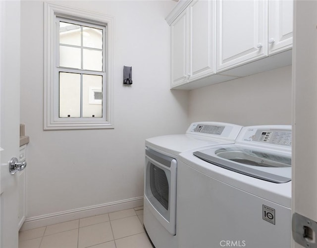 washroom featuring cabinets, light tile patterned floors, and independent washer and dryer