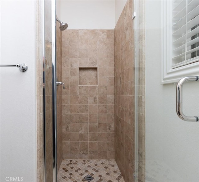 bathroom featuring a shower with door