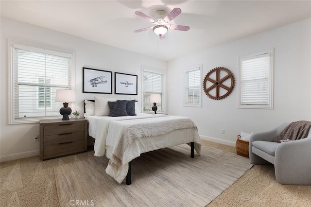 bedroom featuring ceiling fan and multiple windows