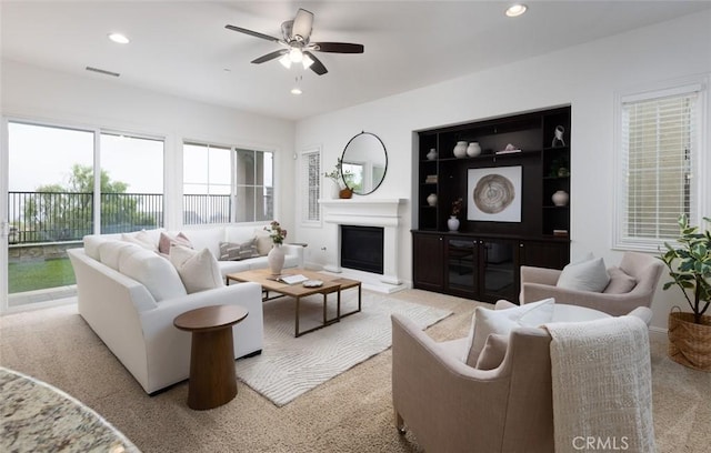 living room featuring ceiling fan and light carpet