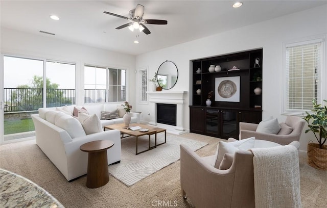 carpeted living room featuring ceiling fan