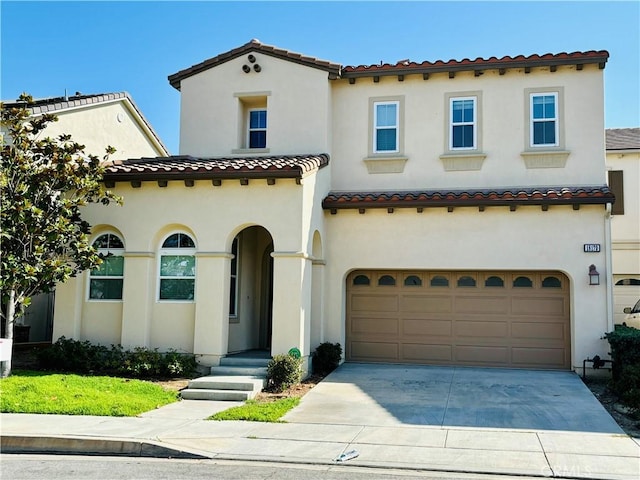 mediterranean / spanish home with a garage