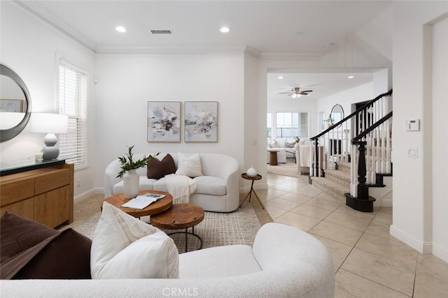 living room featuring light tile patterned floors, ornamental molding, and ceiling fan