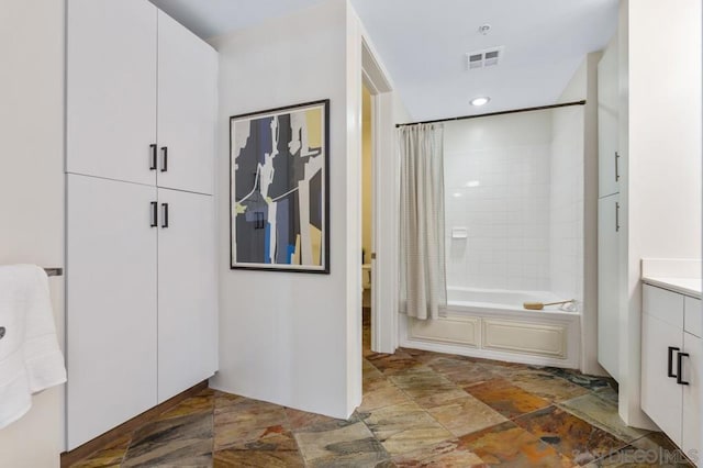 bathroom featuring shower / tub combo and vanity