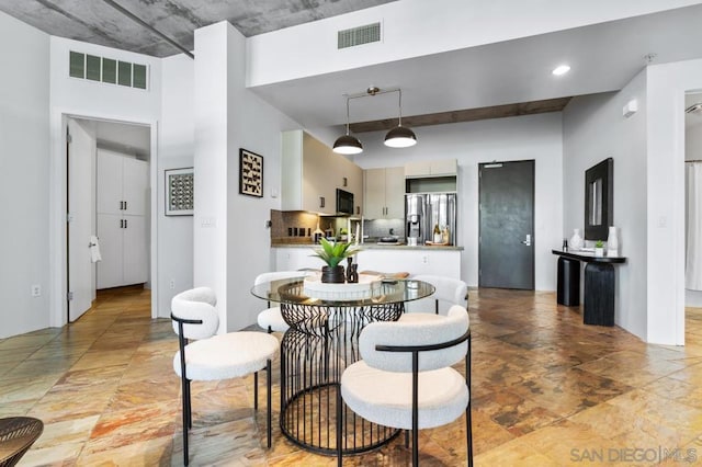 dining room featuring a high ceiling