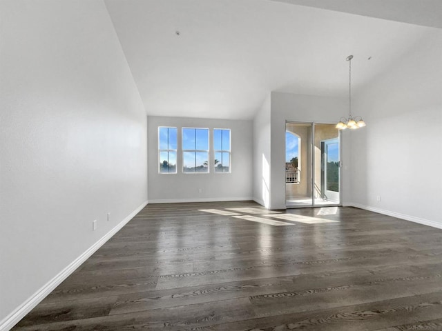 unfurnished living room featuring dark hardwood / wood-style flooring, high vaulted ceiling, and a notable chandelier