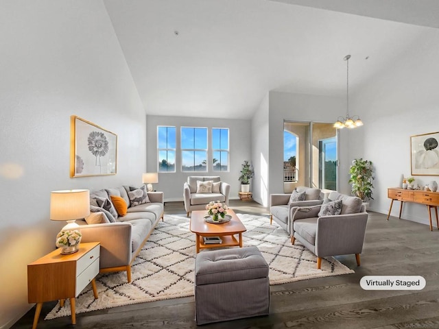 living room featuring a chandelier, hardwood / wood-style floors, and high vaulted ceiling