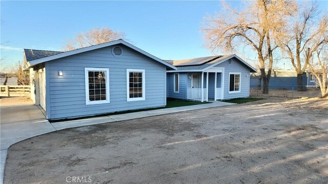 ranch-style house with solar panels