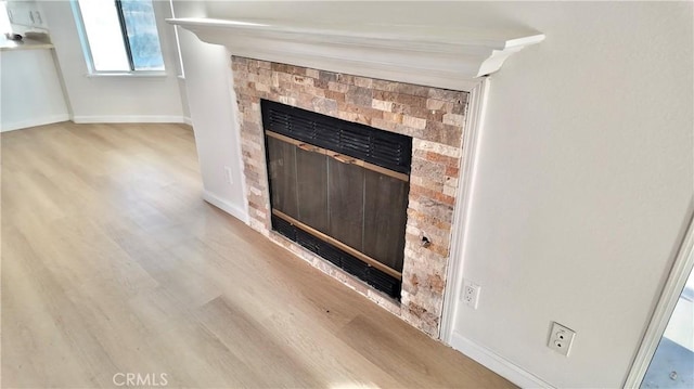 room details with a fireplace and hardwood / wood-style flooring