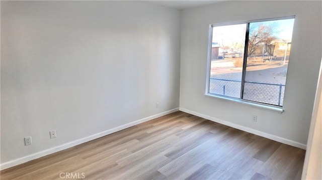 spare room with a healthy amount of sunlight and light hardwood / wood-style floors