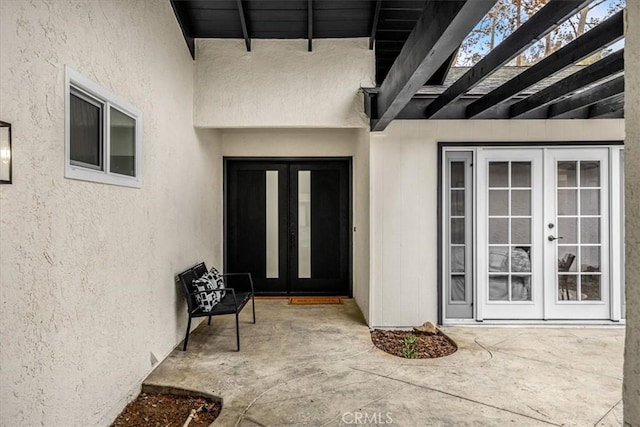 doorway to property featuring a patio area and french doors