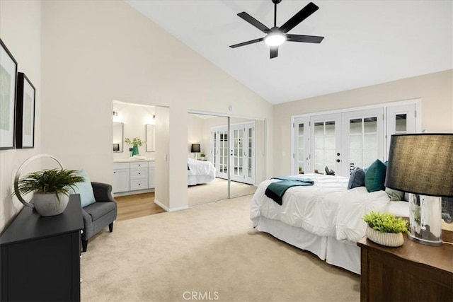 carpeted bedroom with ceiling fan, connected bathroom, access to exterior, french doors, and high vaulted ceiling