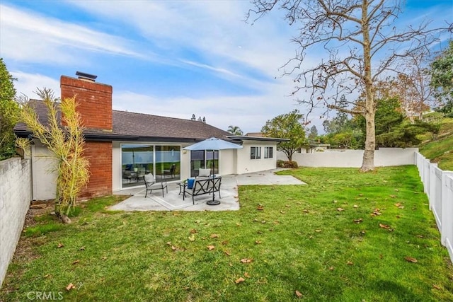 back of property featuring a patio area and a lawn