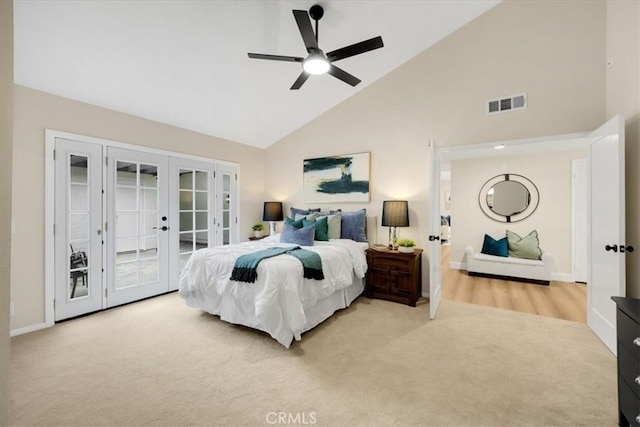 bedroom with ceiling fan, access to exterior, high vaulted ceiling, light carpet, and french doors