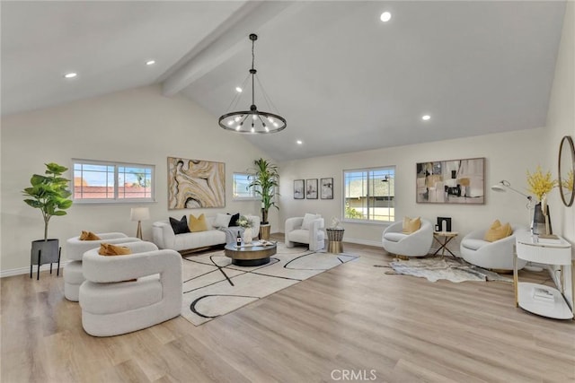 living room featuring lofted ceiling with beams, light wood-type flooring, and a chandelier