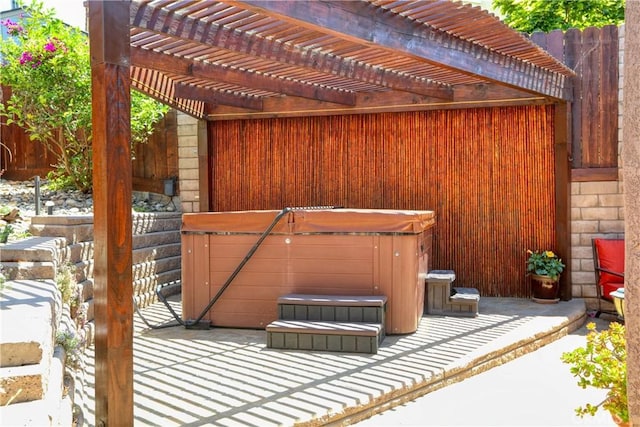 exterior space featuring a hot tub and a pergola