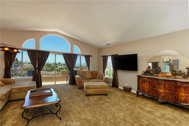 carpeted living room with a healthy amount of sunlight and vaulted ceiling