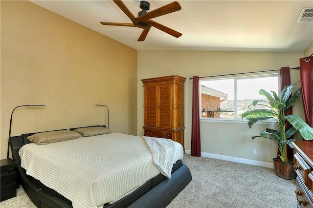 carpeted bedroom with ceiling fan and vaulted ceiling