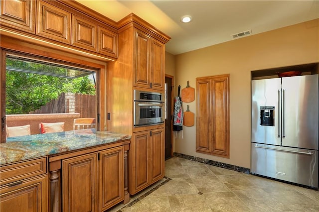 kitchen featuring light stone counters and stainless steel appliances