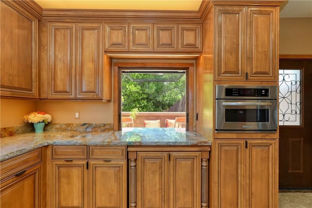 kitchen with oven and light stone counters