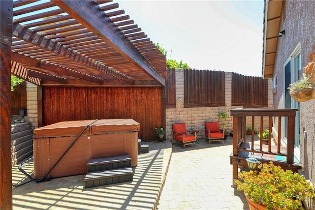 view of patio / terrace with a pergola and a hot tub