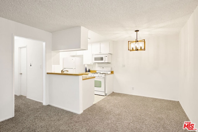 kitchen featuring decorative light fixtures, light colored carpet, kitchen peninsula, white appliances, and white cabinets