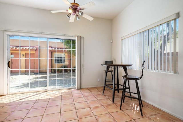 dining area with ceiling fan and light tile patterned flooring