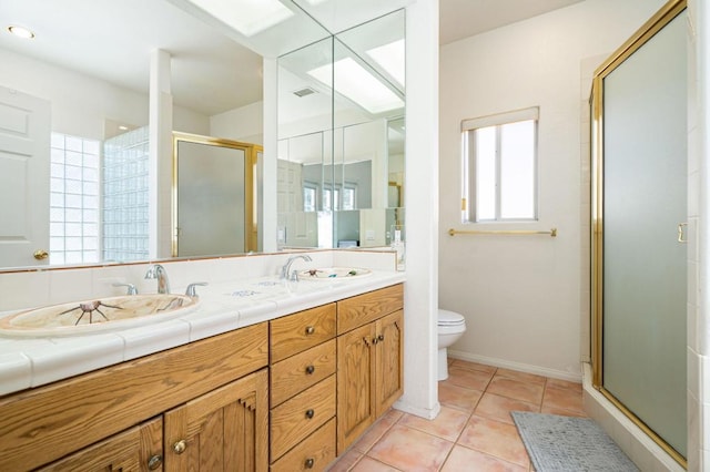 bathroom with toilet, tile patterned floors, an enclosed shower, and vanity