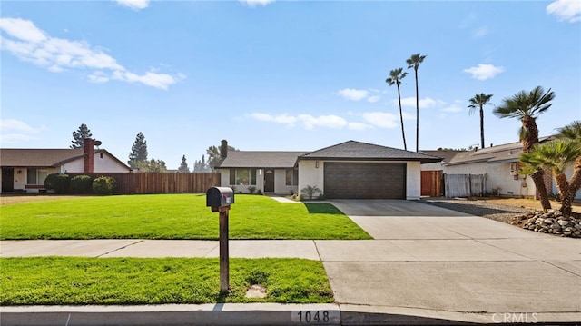 ranch-style house featuring a front lawn and a garage