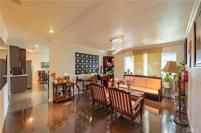 interior space with dark tile patterned floors, an inviting chandelier, and ornamental molding