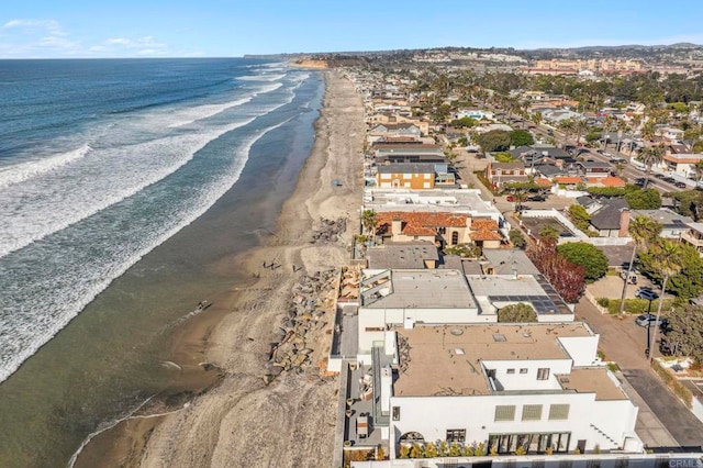 bird's eye view featuring a water view and a view of the beach