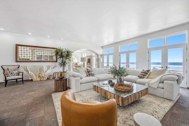 living room featuring french doors and a water view