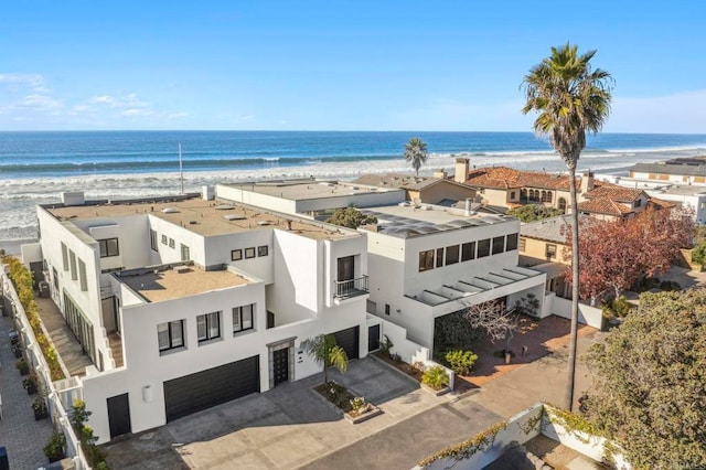 birds eye view of property with a beach view and a water view