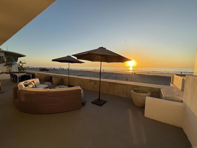 patio terrace at dusk with a water view and outdoor lounge area